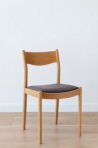 Wooden chair with gray cushion on wooden floor