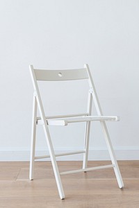 Modern white chair on wooden floor