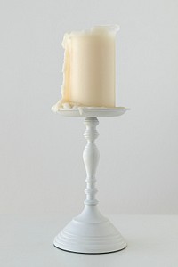 White candle on a plated candlestick