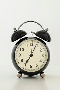 Vintage black analog clock on off white background