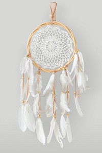 White dream catcher hanging on a off white wall