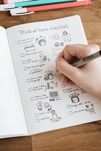 Girl doodling and making a checklist in a notebook