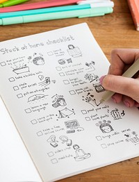 Girl doodling and making a checklist in a notebook