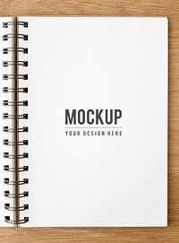 White ruled notebook mockup on a wooden table