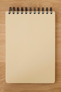 Brown ruled notebook mockup on a wooden table