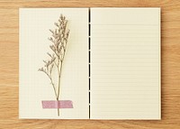 Dried flower on a blank lined notebook mockup