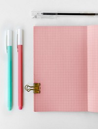 Pink grid patterned notebook page with stationary mockup