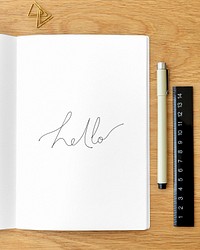 Hello written on a notebook page with stationary mockup
