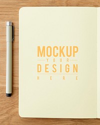 Blank plain yellow notebook page with a pen mockup
