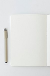 Blank plain white notebook page with a pen