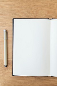 Blank plain white notebook page with a pen