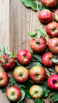 Red ripe apples and leaves on dark wooden table mobile phone wallpaper