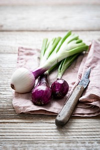 Red spring onion on wooden table