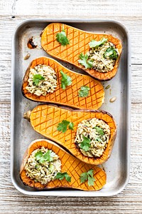 Delicious roasted butternut squash curry rice bowl on wooden table