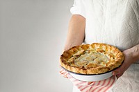 Baker holding a freshly baked cherry pie yummy dessert