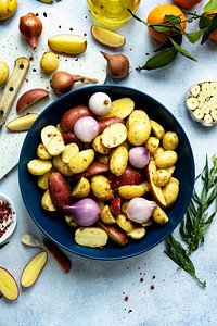 Mixed roasted potatoes with red onions food photography