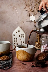 Pouring hot chocolate from a kettle food photography