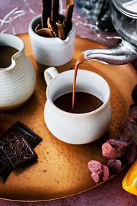 Pouring hot chocolate from a kettle food photography