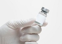 Doctor&#39;s hand holding medicine glass vial with blank white label