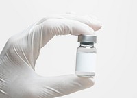 Scientist&#39;s hand holding medicine glass bottle with blank white label