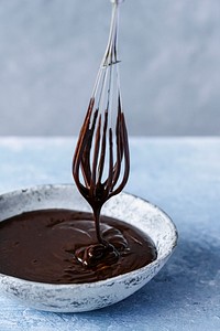 Chocolate ganache being whisked in a bowl food photography