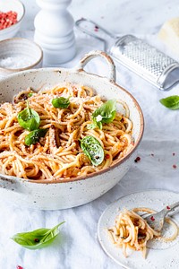 Spaghetti with marinara tomato sauce topped with parmesan and basil food photography