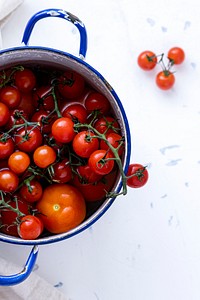 Freshly washed tomatoes in a pot