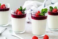 Vanilla panna cotta with raspberry served in a glass food photography