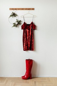 Red off shoulder sequin dress on a wall hanger