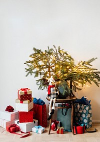 Festive presents under a minimal Christmas tree poster