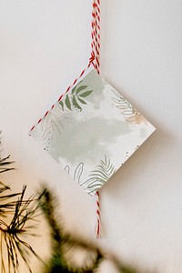 Greenery card hanging by the wall
