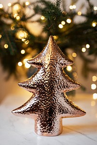 Shiny decorative Christmas tree on the table