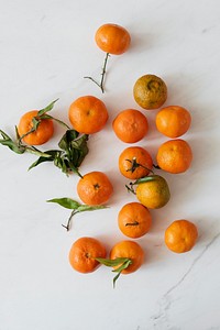 Bright clementines on a marble countertop