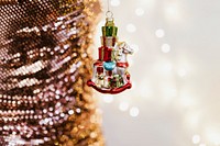 Christmas ornament next to a pink glittery texture