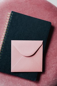 Pink envelope on a black notebook 