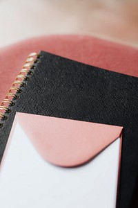 Pink envelope on a black notebook