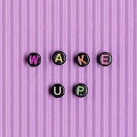 Black WAKE UP beads message typography