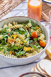 Rotini pasta salad with arugula and cherry tomatoes, healthy summer dish