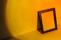 Blank picture frame with yellow sunset projector lamp