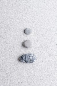 Marble zen stones stacked on white background in stability concept