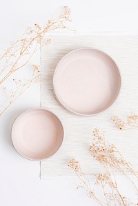 Pink plate in flat lay style with dried flowers