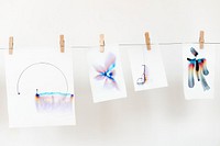 Aesthetic chromatography art on white papers hanging on a rope