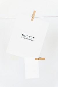 Papers mockup psd hanging from a rope with paper clips