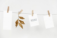 Papers mockup psd hanging from a rope with paper clips