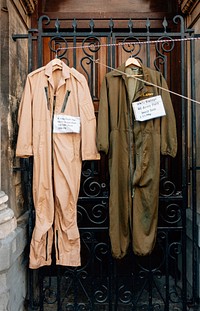 US army jump suit hanging on a gate