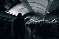 Silhouette of people in a subway tunnel
