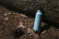 Blue water bottle in the forest