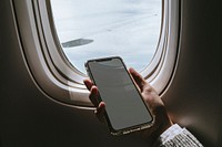 Woman using a smartphone on an airplane