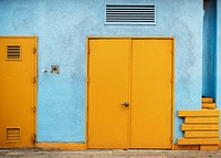 Yellow doors with a pale blue wall