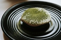 Green tea donut on a black plate